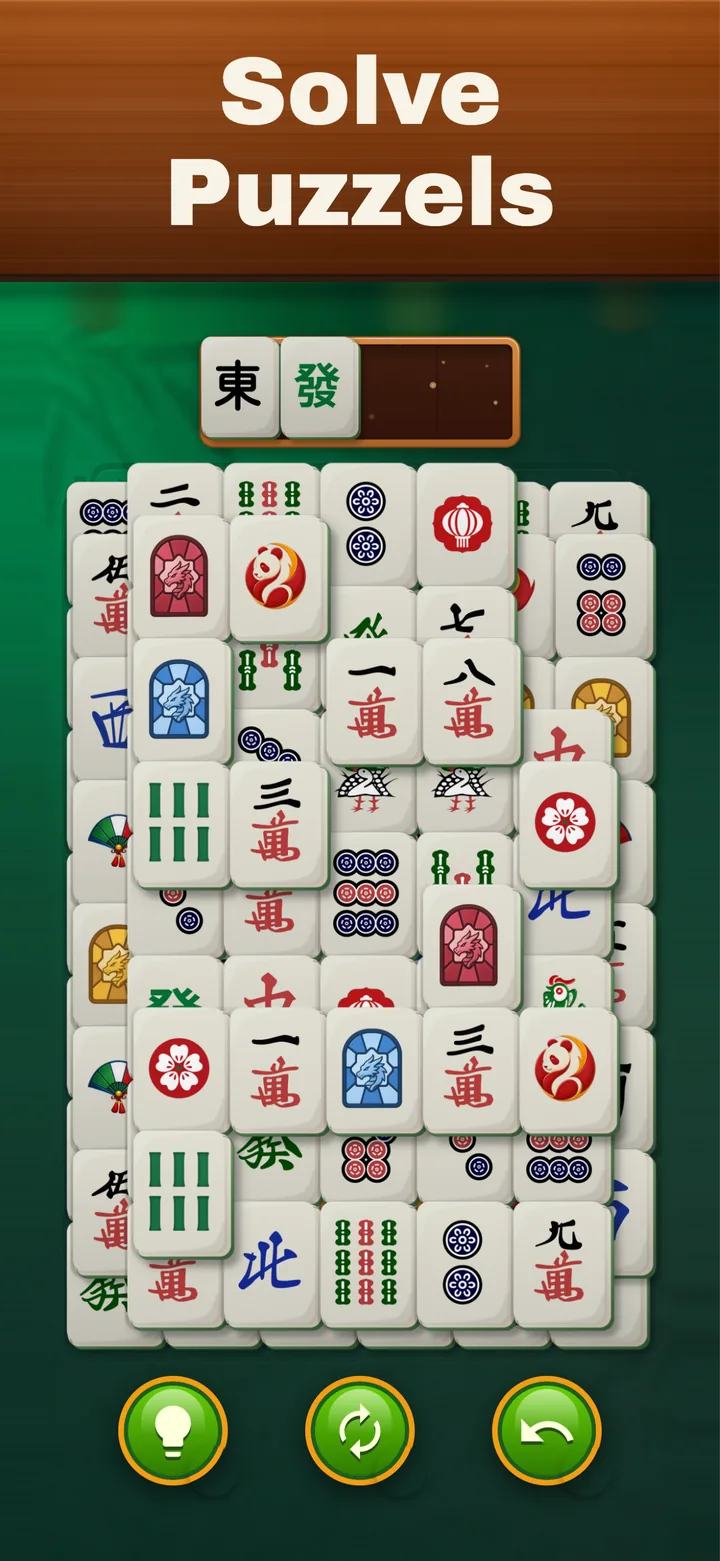 Mahjong Elite on iPhone: A dense, layered board with the tile tray at the top